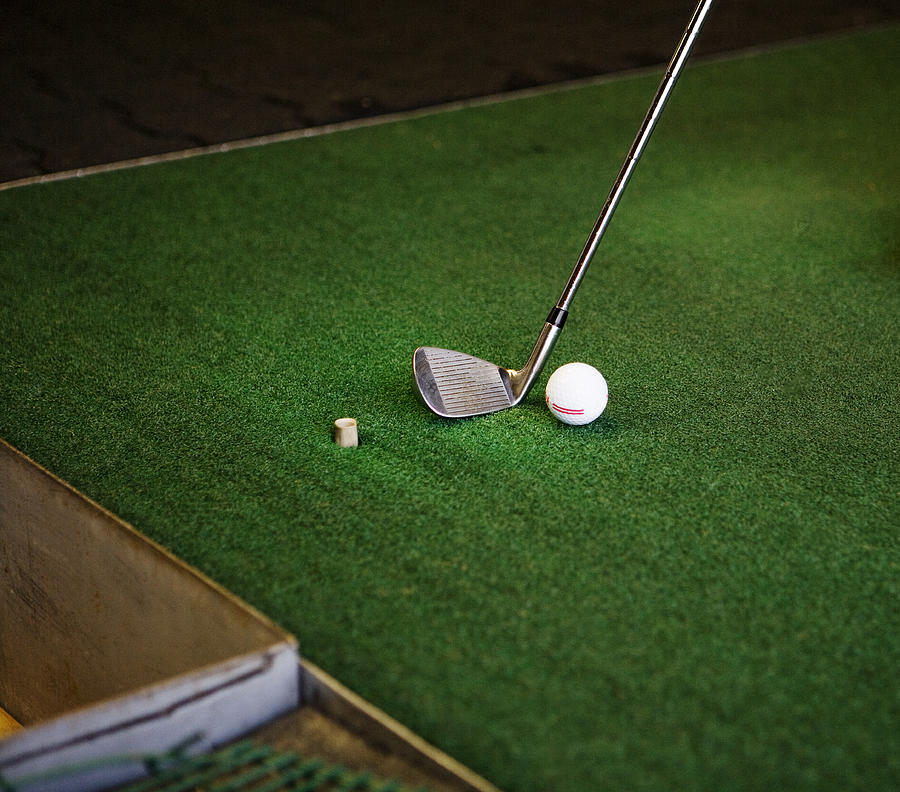 Golf club and ball on green turf, close up Photograph by Frank Rothe