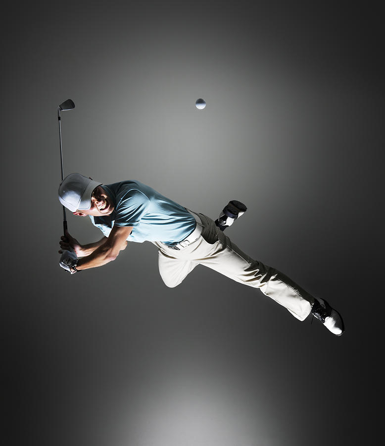 Golf player hanging in the air. Photograph by Henrik Sorensen