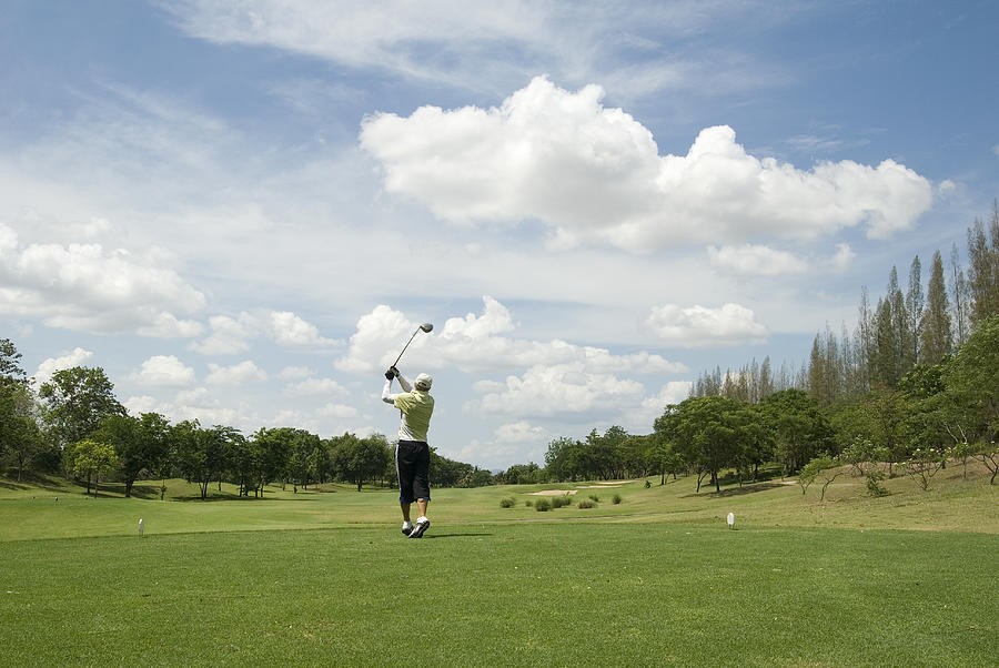 Golf player in action in tropical golf course in Thailand Photograph by Joakimbkk