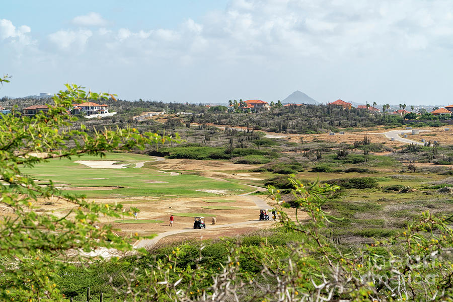 Golfers play the course at the Tierra Del Sol Resort on the Cari Photograph by William Kuta