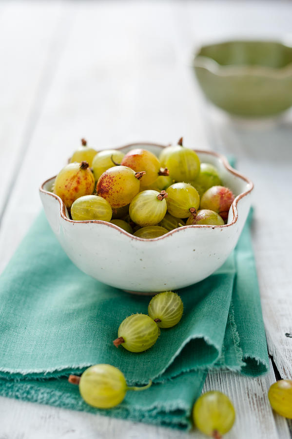 Gooseberries in white bowl Photograph by Sarka Babicka