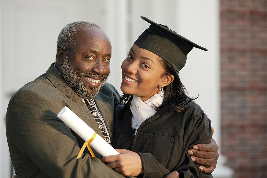 Graduate and father Photograph by Comstock Images