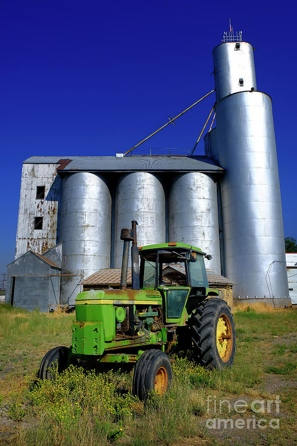 Grain Elevator Silo with Old Green Tractor Photograph by Lane Erickson