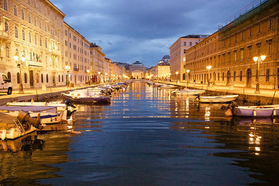 Grand canal with boats at night in Trieste, Italy Photograph by Alexander Spatari