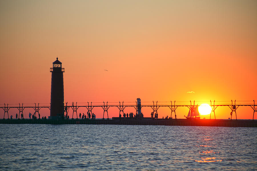 Grand Haven Pier Lighthouse (1905) on Lake Michigan at sunset Photograph by Rainer Grosskopf