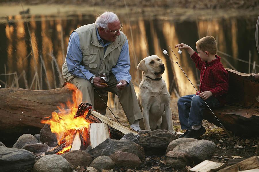Grandfather And Grandson Roast Marshmallows On The Beach Photograph by Mitch Kezar / Design Pics