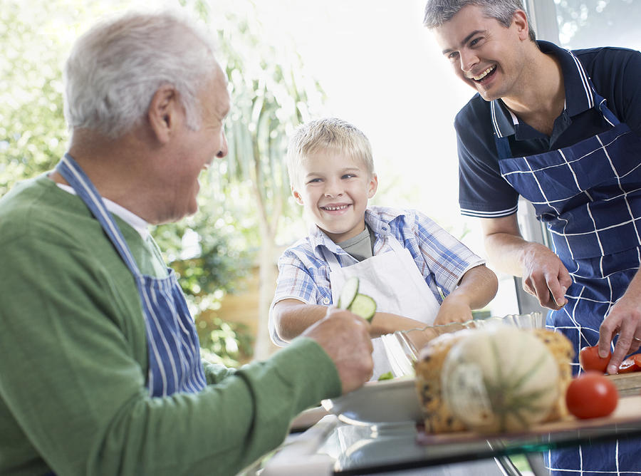 Grandfather, father and son preparing healthy meal Photograph by Sam Edwards