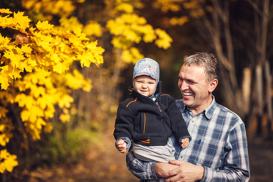 Grandfather Holding His Grandchild On Arm, Autumn Photograph by Miroha141