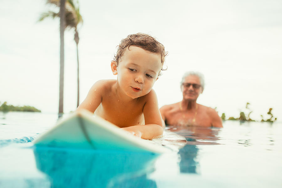 Grandfather teaching grandson to surf Photograph by Orbon Alija