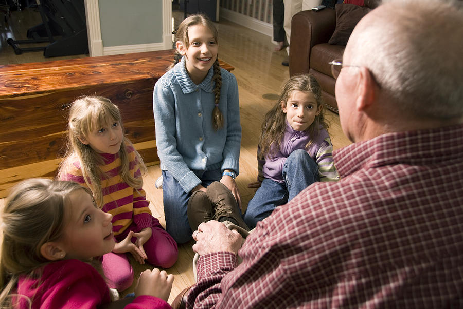 Grandfather telling a story to Grandchildren Photograph by Blue_Cutler