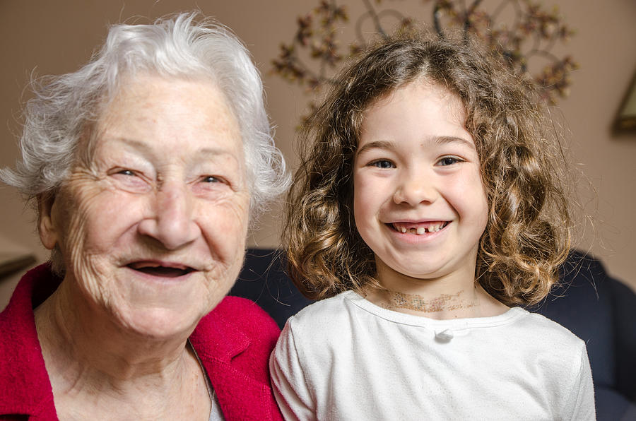Grandmother and granddaughter both showing lack of teeth by smiling Photograph by Marc Dufresne