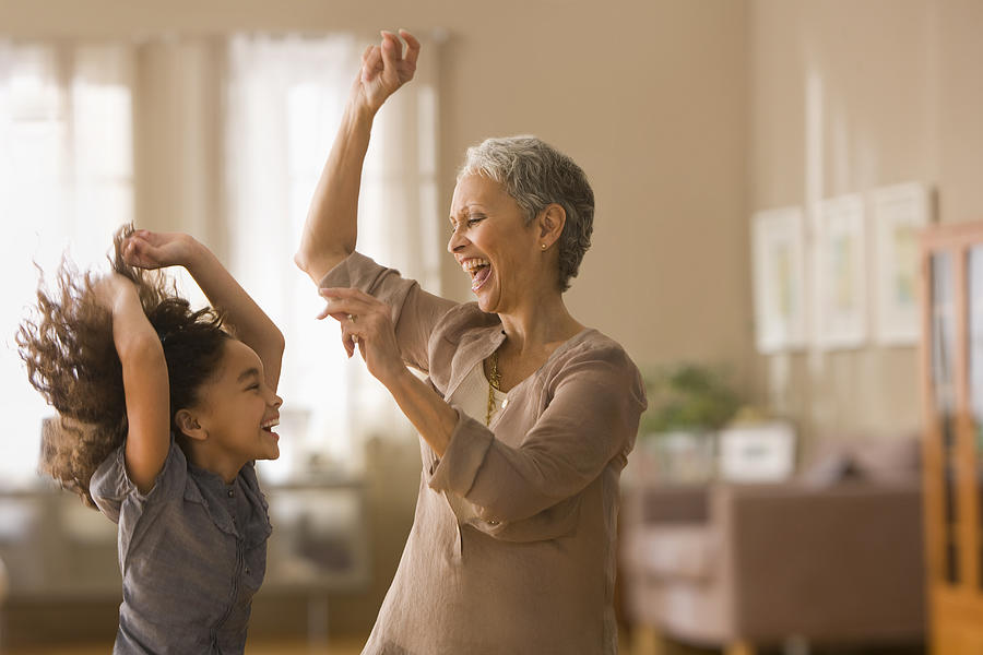 Grandmother and granddaughter dancing together Photograph by Jose Luis Pelaez Inc