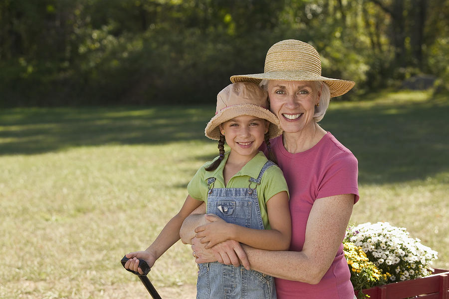 Grandmother and granddaughter gardening Photograph by Comstock Images