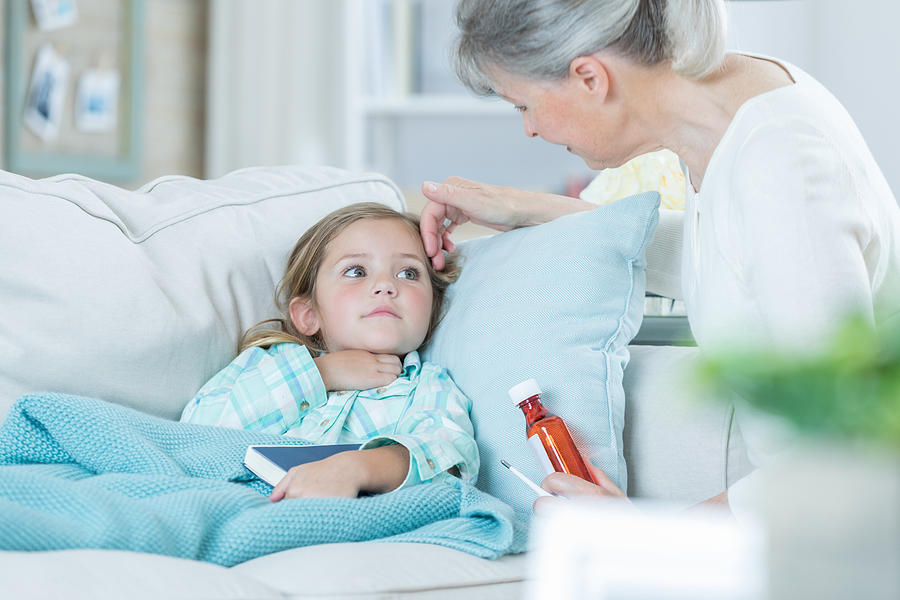 Grandmother cares for sick grandchild Photograph by SDI Productions