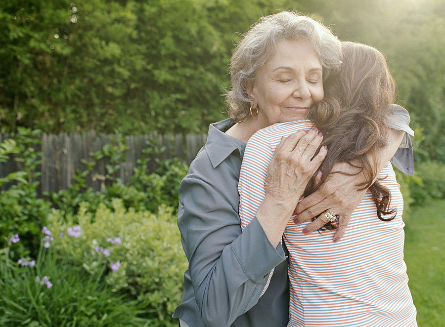Grandmother embracing adult granddaughter Photograph by Siri Stafford