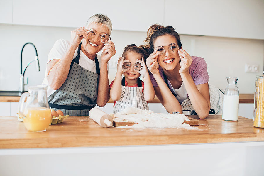 Grandmother, mother and daughter having fun in the kitchen Photograph by Pixelfit
