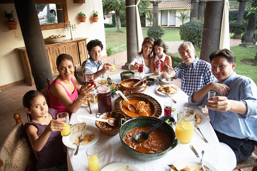 Grandparents, parents and children (7-15) toasting at dinner, portrait Photograph by Edgardo Contreras
