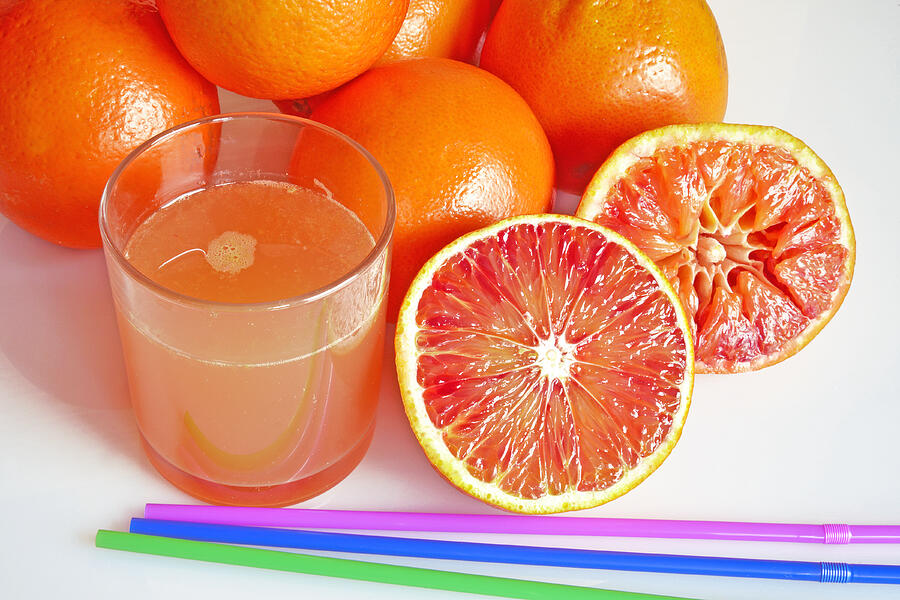 Grapefruit juice and slice of grapefruit Photograph by lucio pepi / FOAP