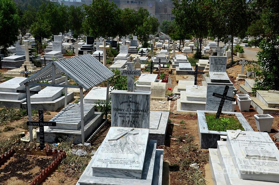 Tree Photograph - Graves and tombstones with crosses at the Christian Cemetery graveyard Karachi Pakistan by Imran Ahmed