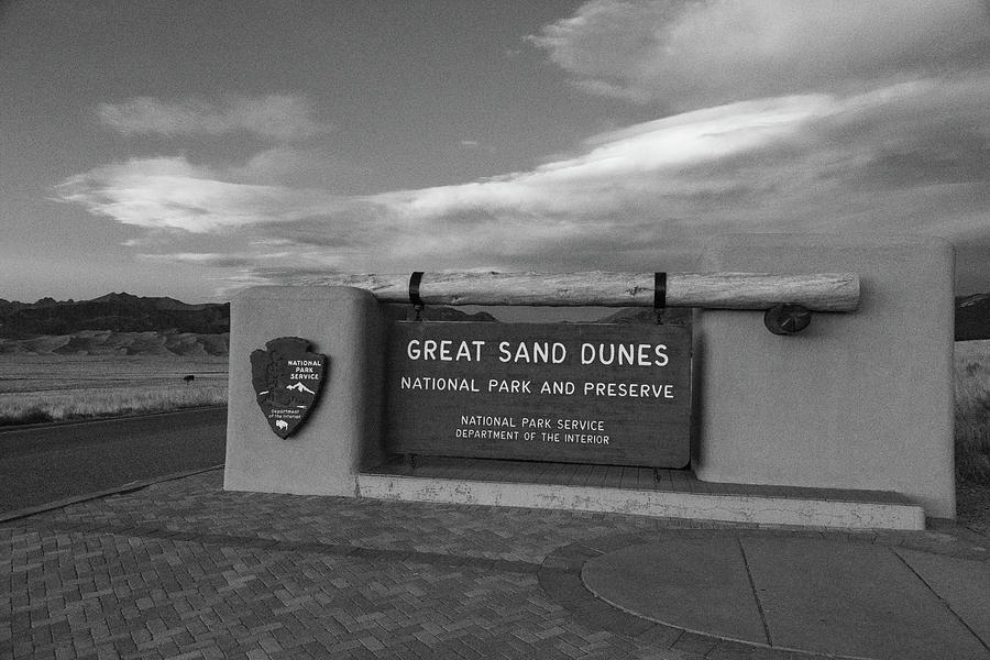 Great Sand Dunes National Park and Preserve sign at dusk in black and white Photograph by Eldon McGraw