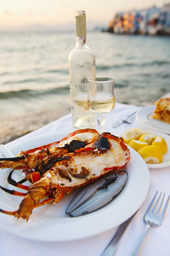Greece, Cyclades Islands, Mykonos, Lobser dinner at coast Photograph by Tetra Images