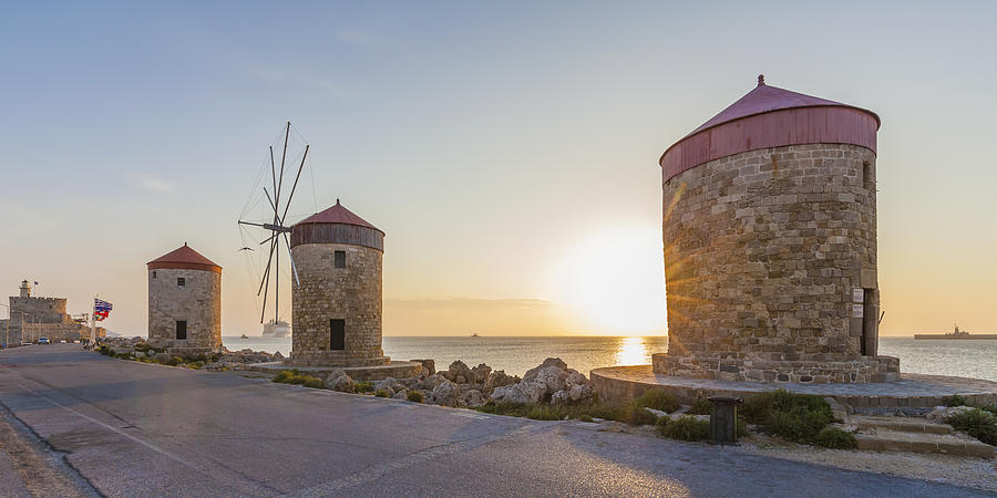 Greece, Rhodes, mole of Mandraki harbour with windmills at sunset Photograph by Westend61