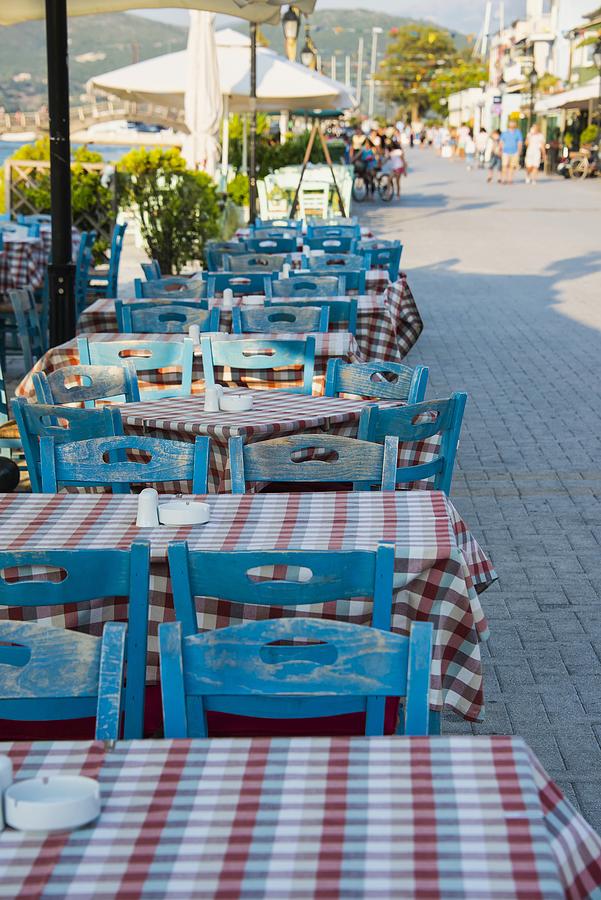 Greek marine with traditional tables and chairs, Lefkada island, Greece Photograph by Paul Biris