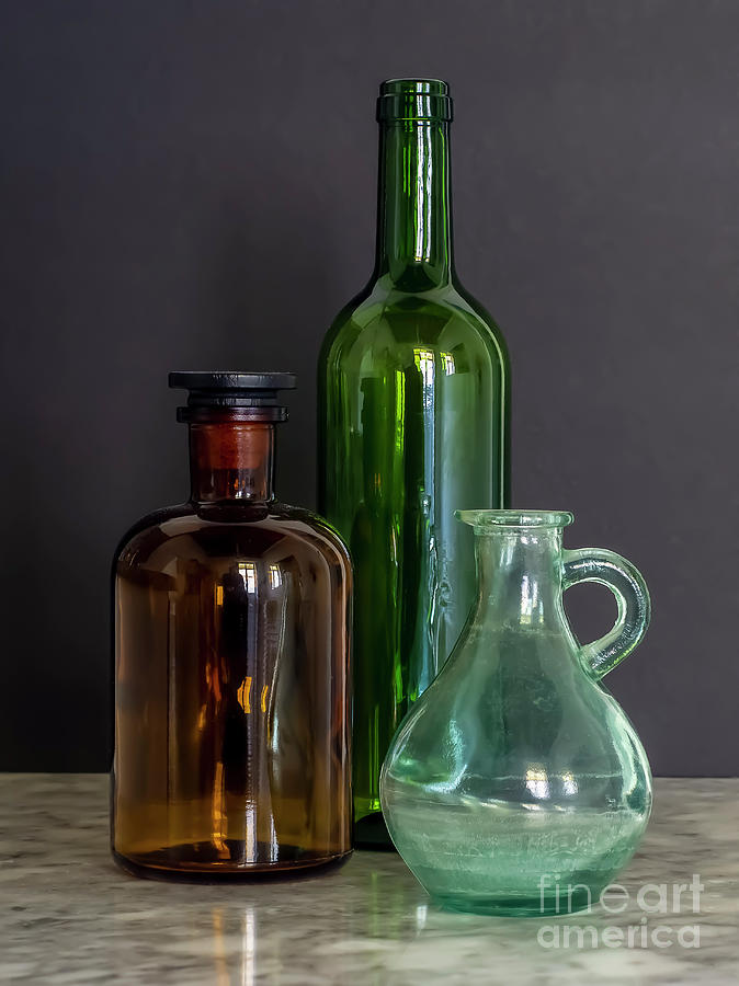 Green and Brown Glass Bottles with Jar on Marble table with Black Background Window Natural Light Still Photograph by Pablo Avanzini