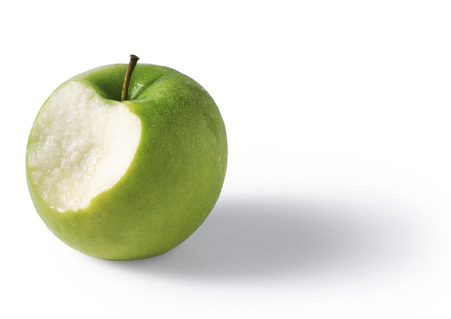 Green apple bitten, granny-smith, white background Photograph by Isabelle Rozenbaum