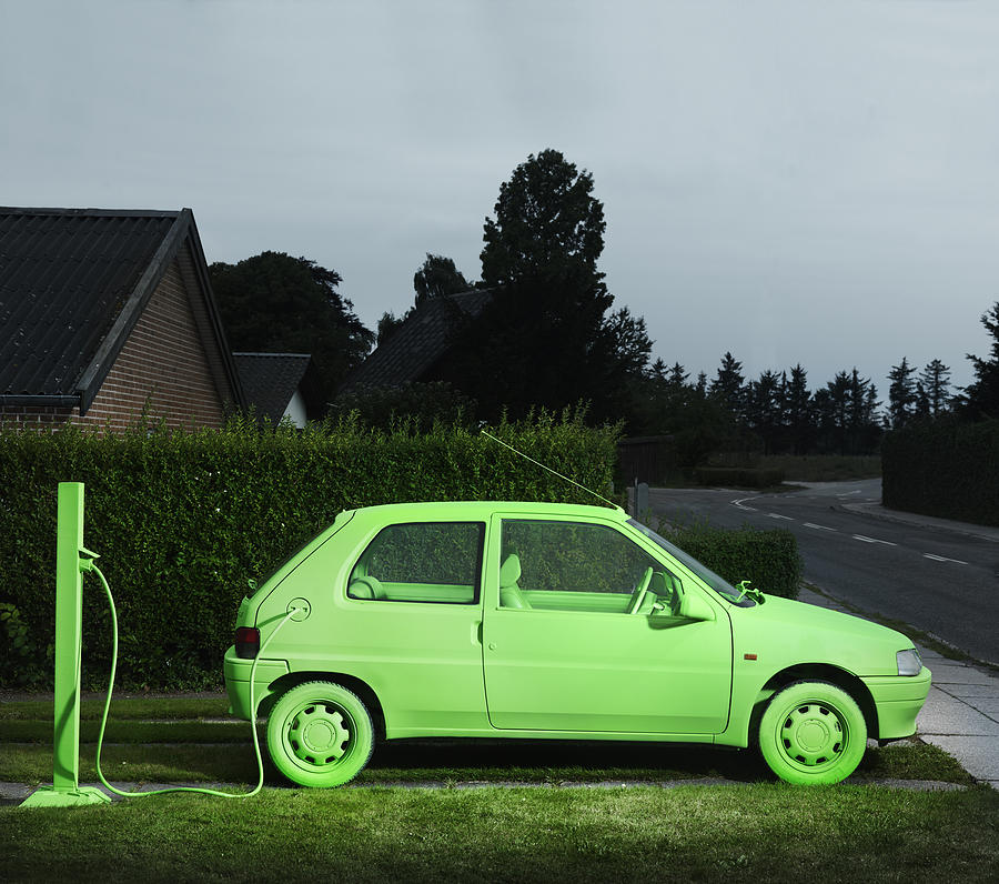 Green car, sustainable energy. (Charging) Photograph by Henrik Sorensen