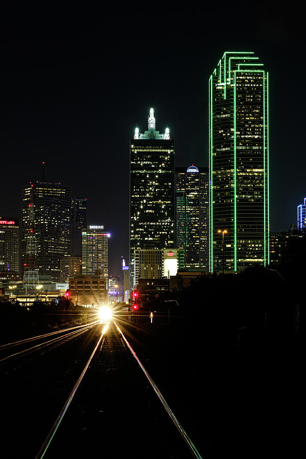 Green Dallas Texas skyline with a train moving out of the city ...