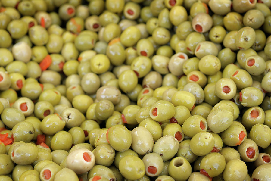 Green olives with pimentos been sold in bulk, Lourmarin, France Photograph by Kevin Oke