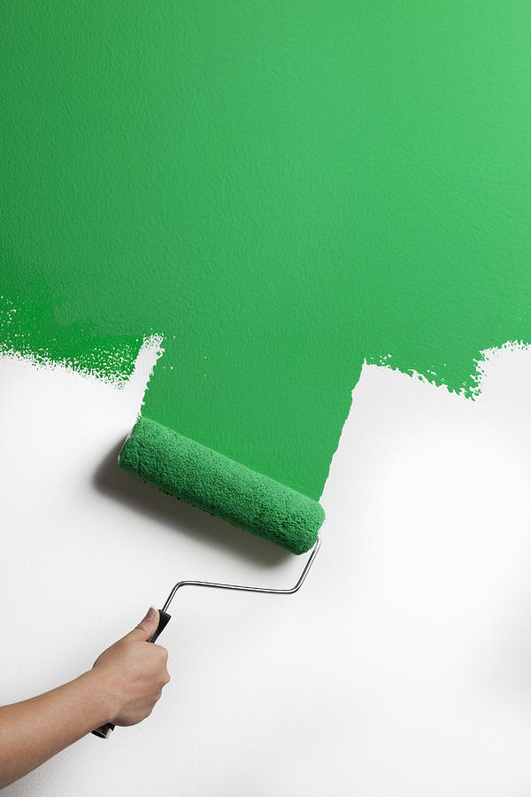 Green paint being rolled onto wall Photograph by Gary S Chapman