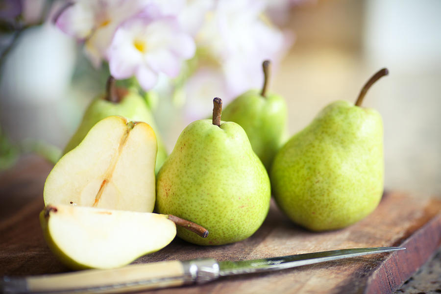 Green Pears on Wooden Board Photograph by Sasha Bell