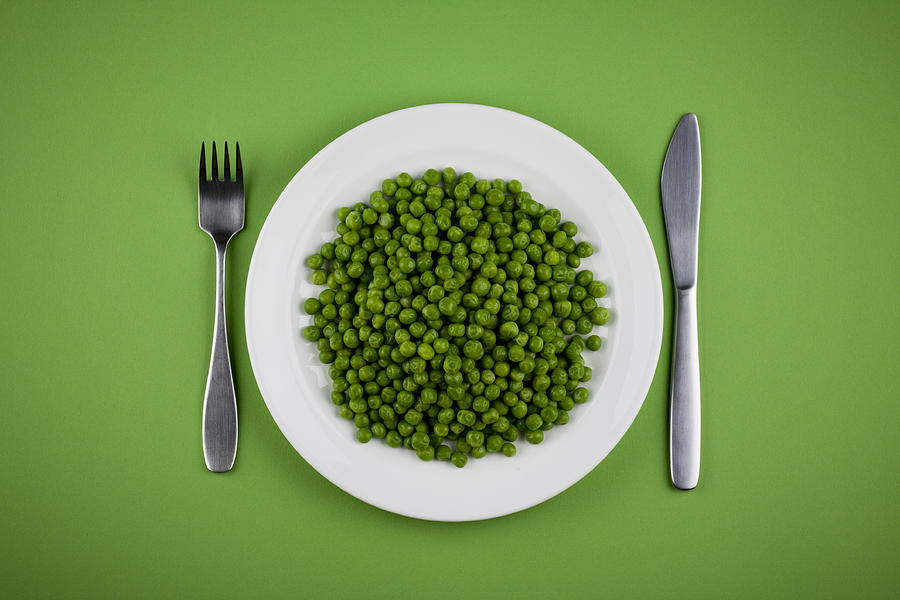 Green Peas on White Plate with Fork and Knife Photograph by Gbrundin