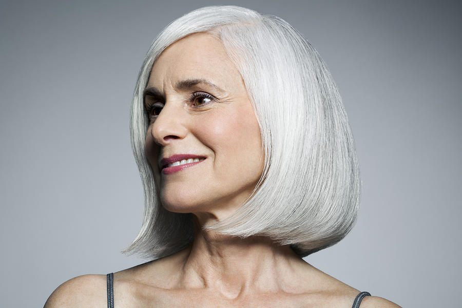 Grey haired woman in 3/4 postion, portrait. Photograph by Andreas Kuehn Grey haired woman in 3/4 postion, portrait. Photograph by Andreas Kuehn