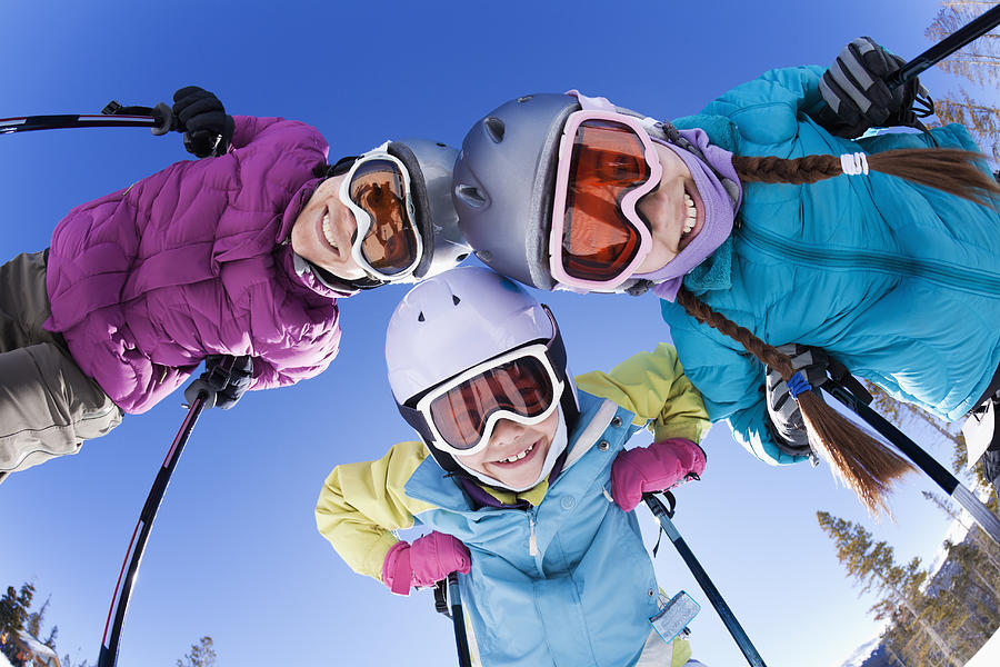Grinning family skiing together Photograph by Don Mason Photography LLC