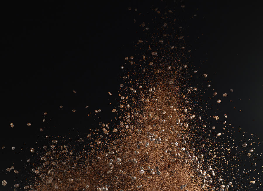 Ground coffee beans in mid-air against black background Photograph by Larry Washburn