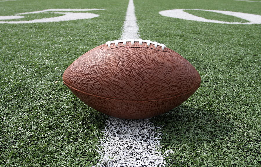 Ground level view of a football on the fifty yard line Photograph by 33ft