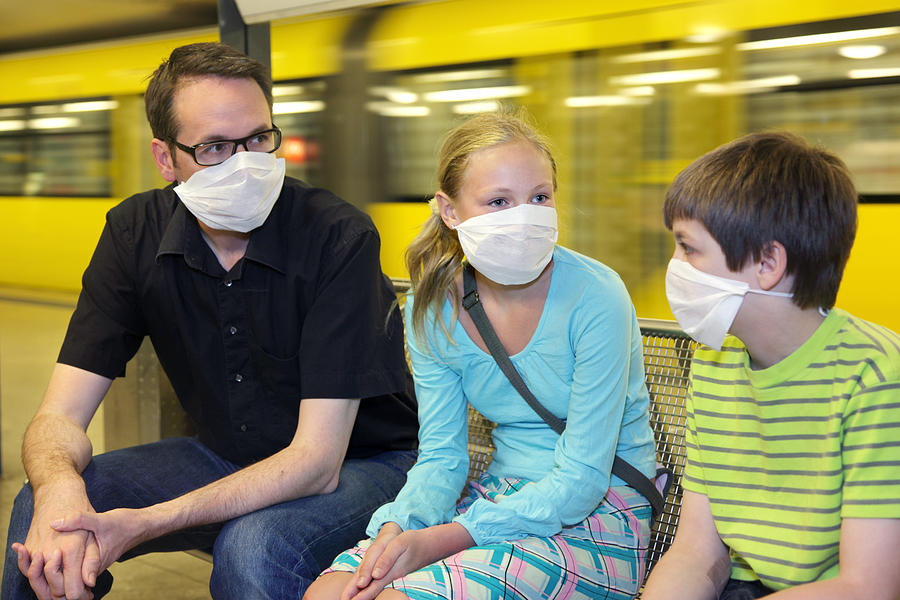 Group of 3 with masks on because of swine flu panic Photograph by Maartje van Caspel