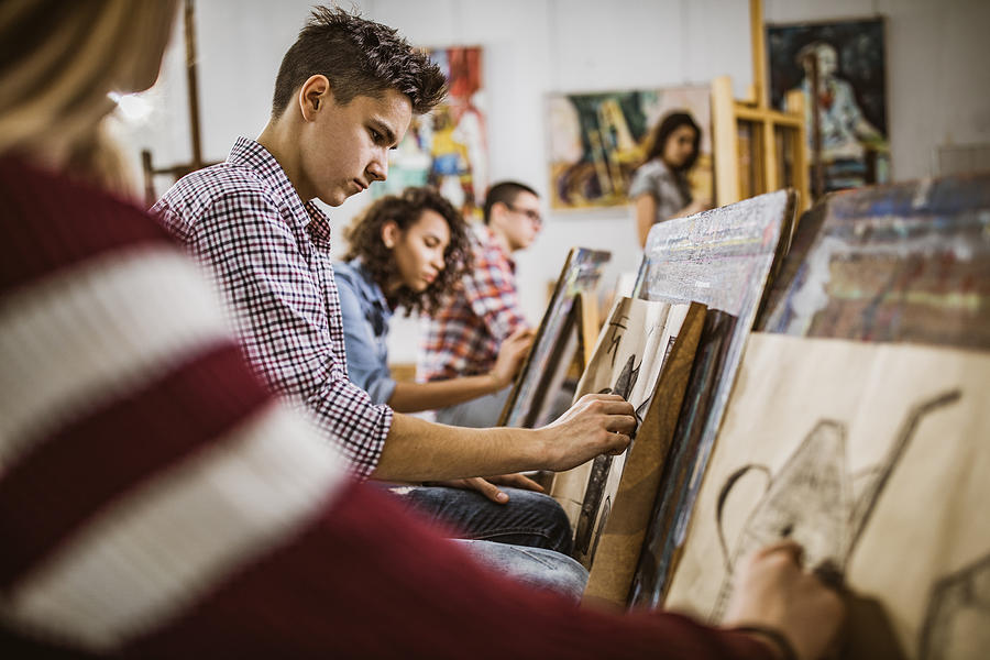 Group of art students drawing paintings at art studio. Photograph by Skynesher
