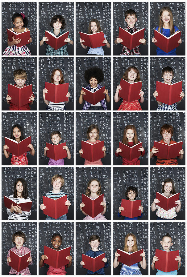 Group of children holding book in class Photograph by Flashpop