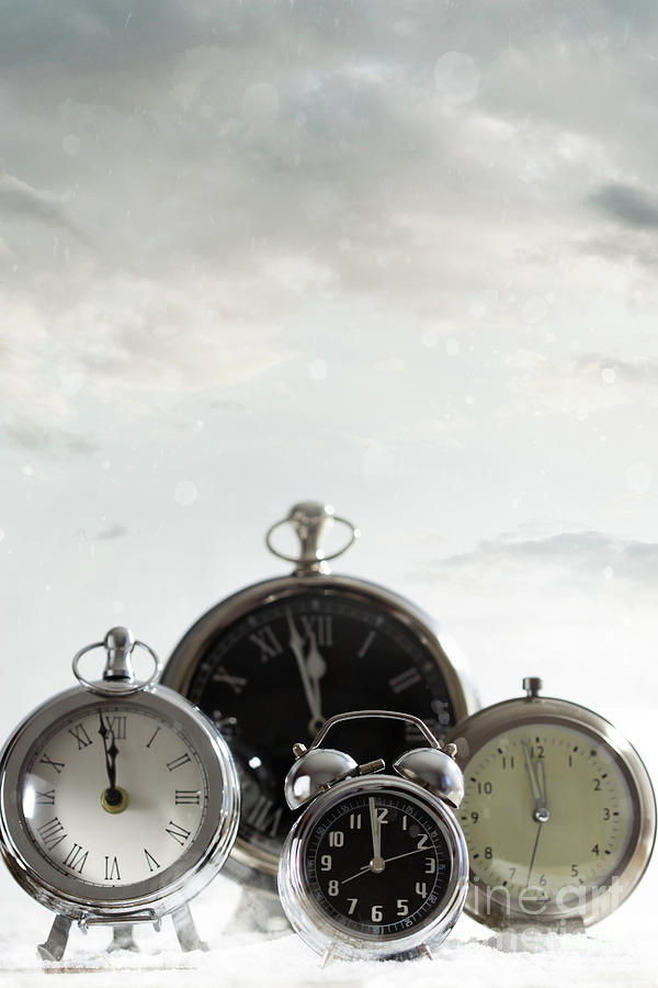 Group of clocks against a cloud background Photograph by Sandra Cunningham