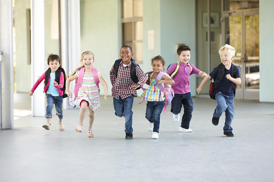 Group Of Elementary Age Schoolchildren Running Outside Photograph by Monkeybusinessimages