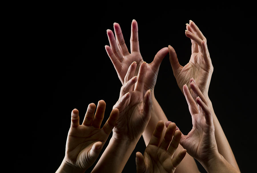 Group of female hands reaching towards the sky Photograph by Juanmonino