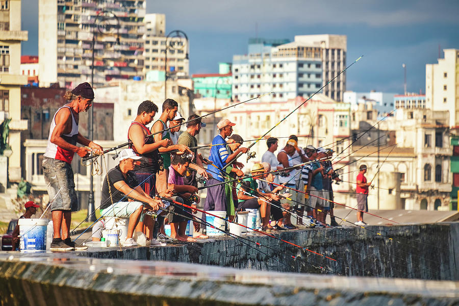Group of fishermen at the famous Malecon seawall in Havana Photograph by Karel Miragaya
