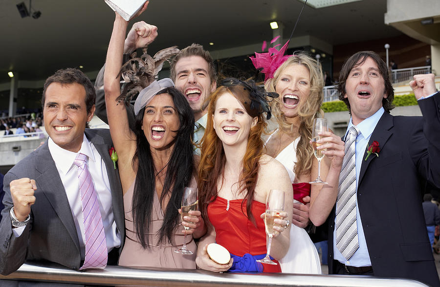Group of friends at the races, cheering Photograph by David Woolley
