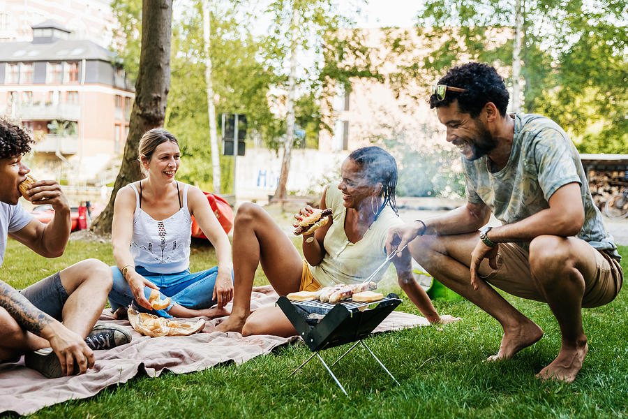 Group Of Friends Having BBQ By Canal Photograph by Tom Werner