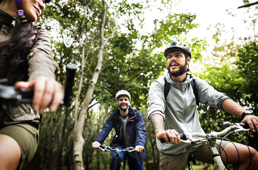 Group of friends ride mountain bike in the forest together Photograph by Rawpixel