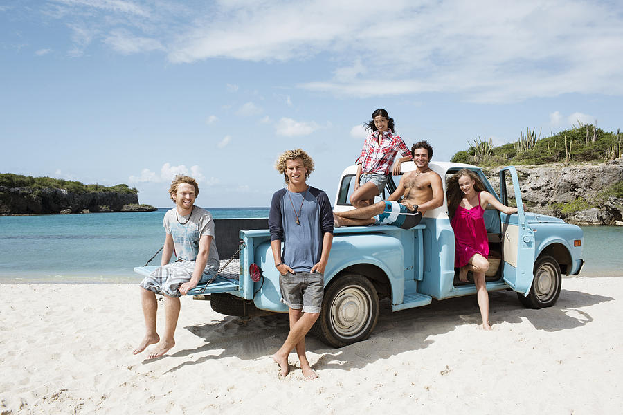 Group of friends with truck on beach Photograph by Felix Wirth